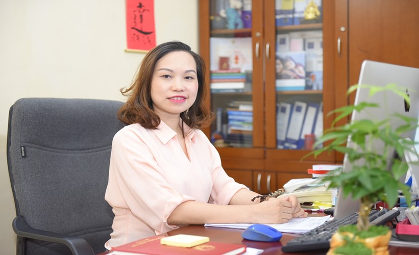 Ms Nguyen Thi Thu Ha working at her office at the Department of National Economic Issues.